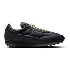 Capturing the 1970s low-profile track silhouette, detailing the anthracite stuffed leather upper, light bone leather overlays, crisp sidewall Swoosh, vintage sail foam wedge midsole, and studded black rubber waffle outsole edge.