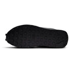 Focusing on the durable full-length black rubber outsole featuring iconic square-studded waffle traction lugs, toe bumper wrap, and classic heel crash curve, showcasing the grip matrix engineered for a successful tackle of city pavements, tarmac, and indoor flooring.