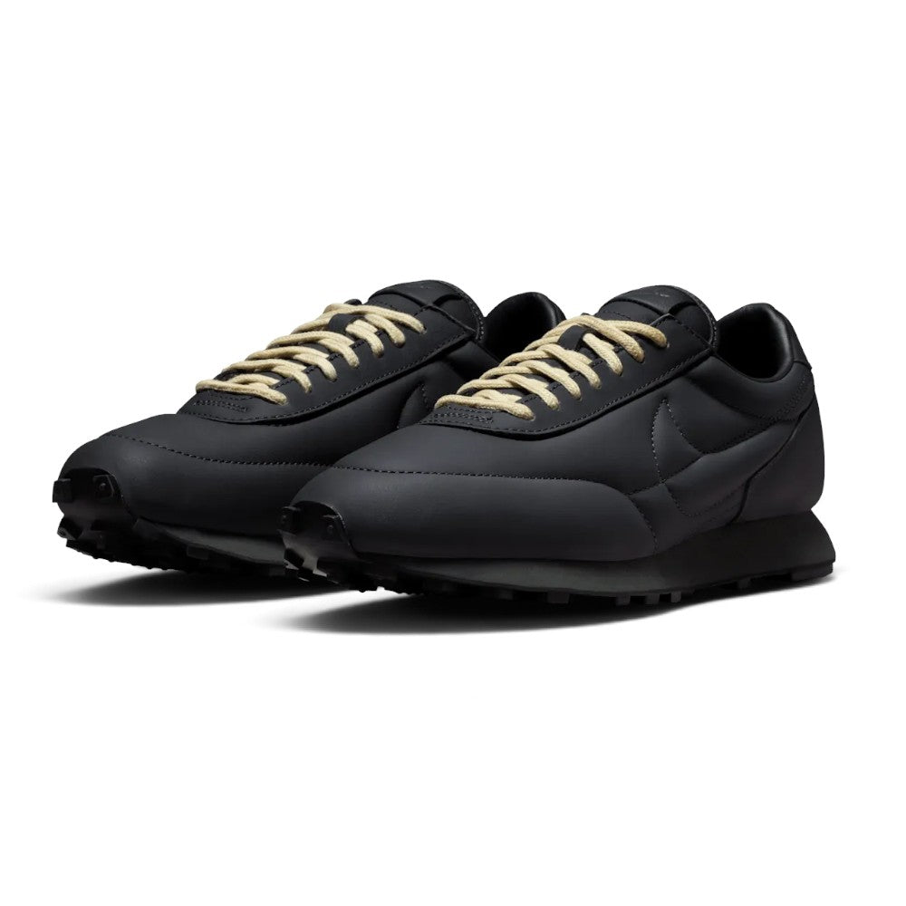 Showcasing the "unreal" clean lines, dimensional puffy leather texture, and anthracite-to-light-bone colourway contrast from a 45-degree perspective.