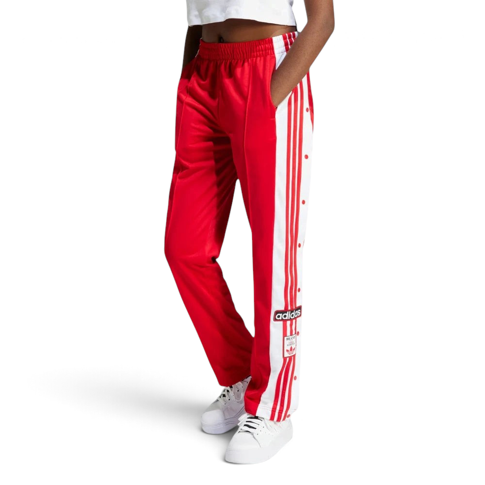 Side profile of the Better Scarlet Adibreak pants, highlighting the full-length white snap buttons and the contrast 3-Stripes.