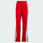 Top-down view of the track bottoms laid flat, showcasing the elasticated drawstring waist and the vibrant red tricot fabric.