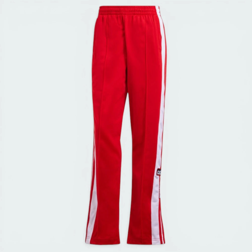 Top-down view of the track bottoms laid flat, showcasing the elasticated drawstring waist and the vibrant red tricot fabric.