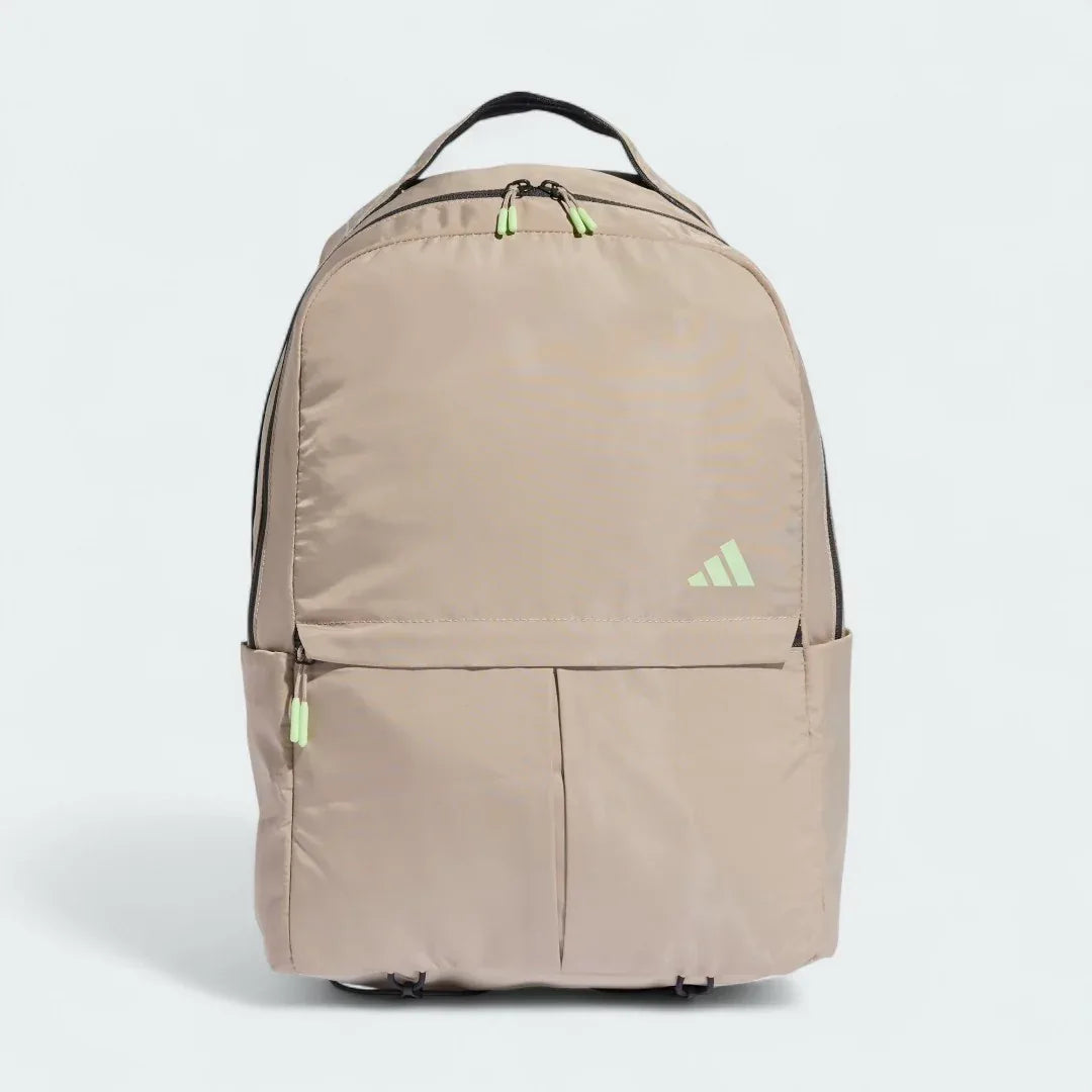 Adidas Women's Workout Backpack Yoga Bag in beige, front view showing main compartment zipper, front pocket, and external yoga mat strap. Main image
