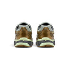 Focuses on the rear profile, displaying the structured synthetic heel counters, micro-Swooshes, ventilation perforations, and the wide base of the ribbed foam midsole