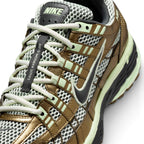 Details the micro-precision of the forefoot area, showing the textured Olive Flak toe box, protective leather toe cap, flat laces, and central tongue webbing strip.