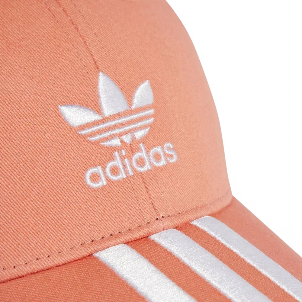 Close-up of an Adidas cap with logo and stripes on a light background