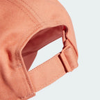 Close-up of a peach-colored cap on a light gray background