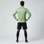 Man wearing the Adidas Handball Goalkeeper Long Sleeve Jersey in green, demonstrating its fit for athletic movement.