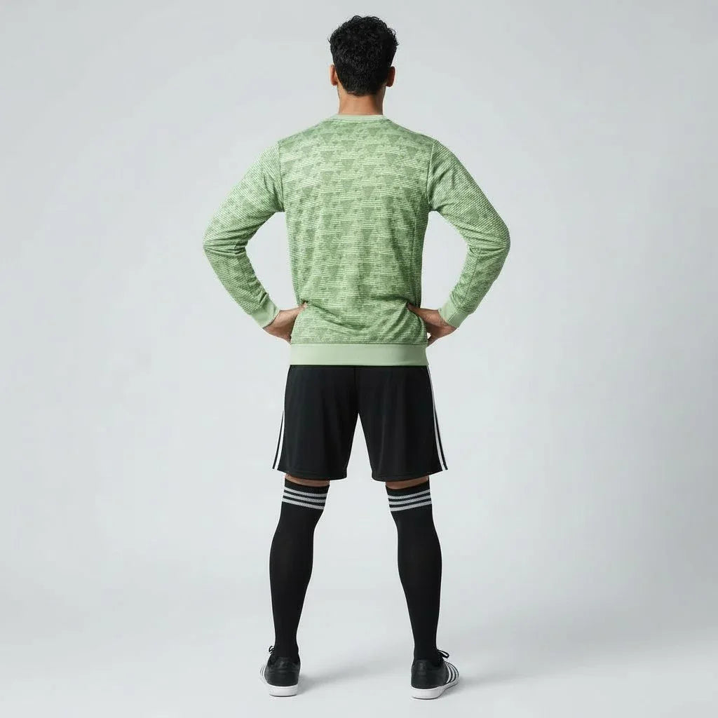 Man wearing the Adidas Handball Goalkeeper Long Sleeve Jersey in green, demonstrating its fit for athletic movement.