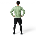 Man wearing the Adidas Handball Goalkeeper Long Sleeve Jersey in green, demonstrating its fit for athletic movement.