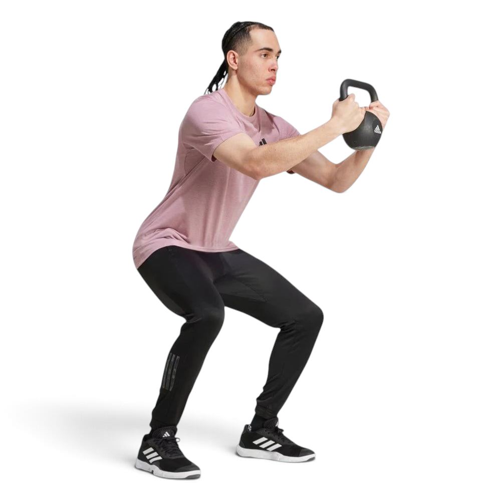 Person performing a kettlebell exercise on a white background