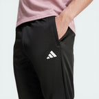 Detailed zoom on the upper legs featuring zip pocket and printed logo
