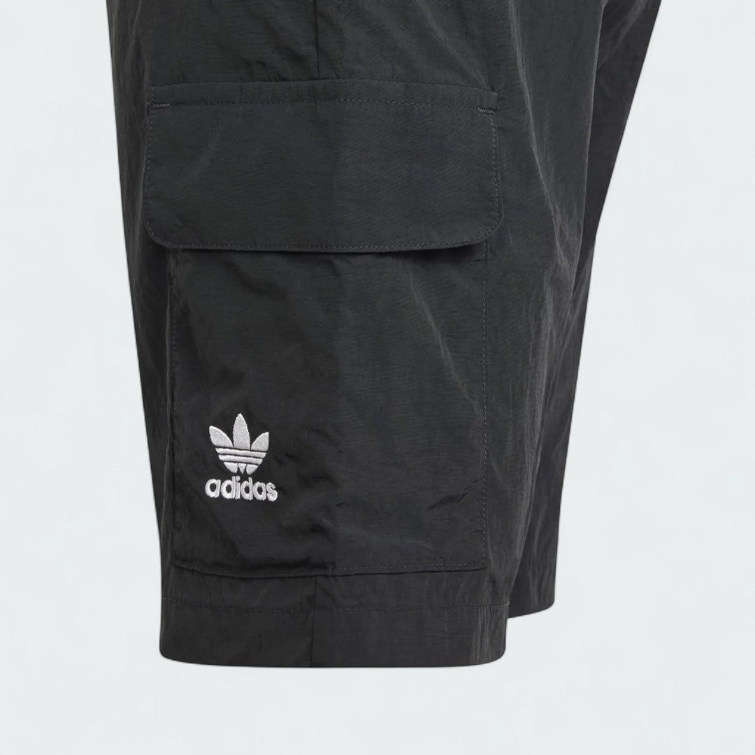 Close-up zoom on the fabric of the Adidas Juniors' Cargo Shorts, showing the recycled nylon texture and the embroidered Trefoil logo.