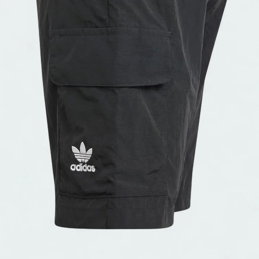 Close-up zoom on the fabric of the Adidas Juniors' Cargo Shorts, showing the recycled nylon texture and the embroidered Trefoil logo.