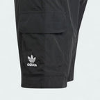 Close-up zoom on the fabric of the Adidas Juniors' Cargo Shorts, showing the recycled nylon texture and the embroidered Trefoil logo.