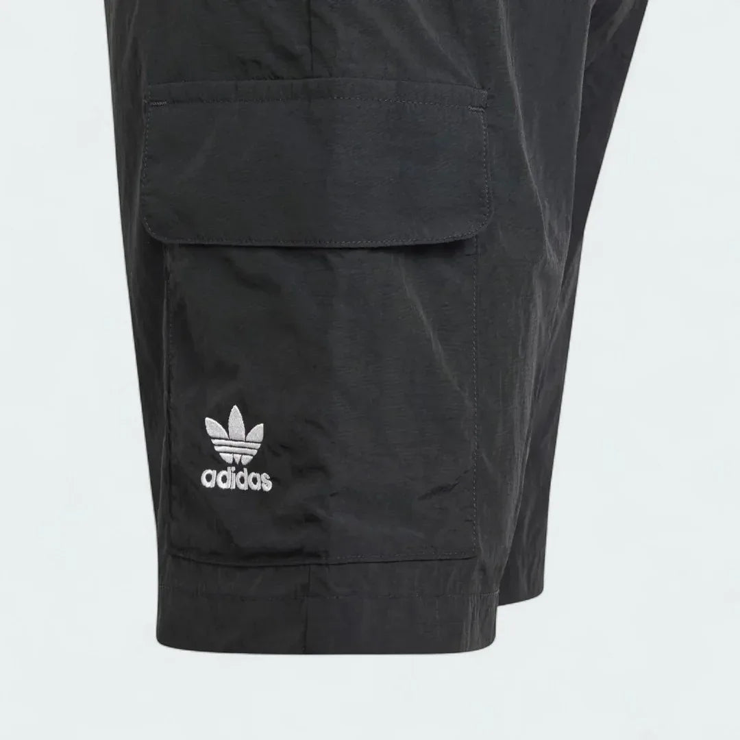 Close-up zoom on the fabric of the Adidas Juniors' Cargo Shorts, showing the recycled nylon texture and the embroidered Trefoil logo.