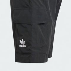Close-up zoom on the fabric of the Adidas Juniors' Cargo Shorts, showing the recycled nylon texture and the embroidered Trefoil logo.