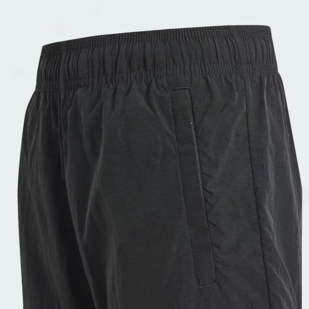 Detailed zoom on the elastic drawcord waist and the zip or flap closure of the cargo pockets of the Adidas Juniors' Cargo Shorts.