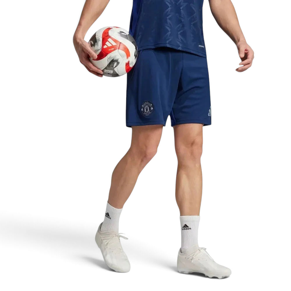 The Night Indigo away shorts, highlighting the embroidered Manchester United shield.