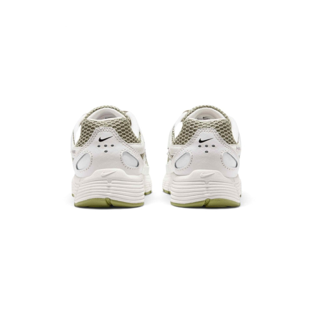 Focuses on the rear profile, highlighting the layered leather heel counter, mini black Swoosh logo, and the wide footprint of the sculpted foam midsole base.