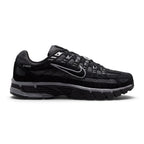 Capturing the 2000s retro running silhouette, detailing the black open-mesh upper, horizontal and vertical anthracite leather overlays, dimensional moulded black Swoosh, sculpted black foam midsole, and dark rubber outsole edge.