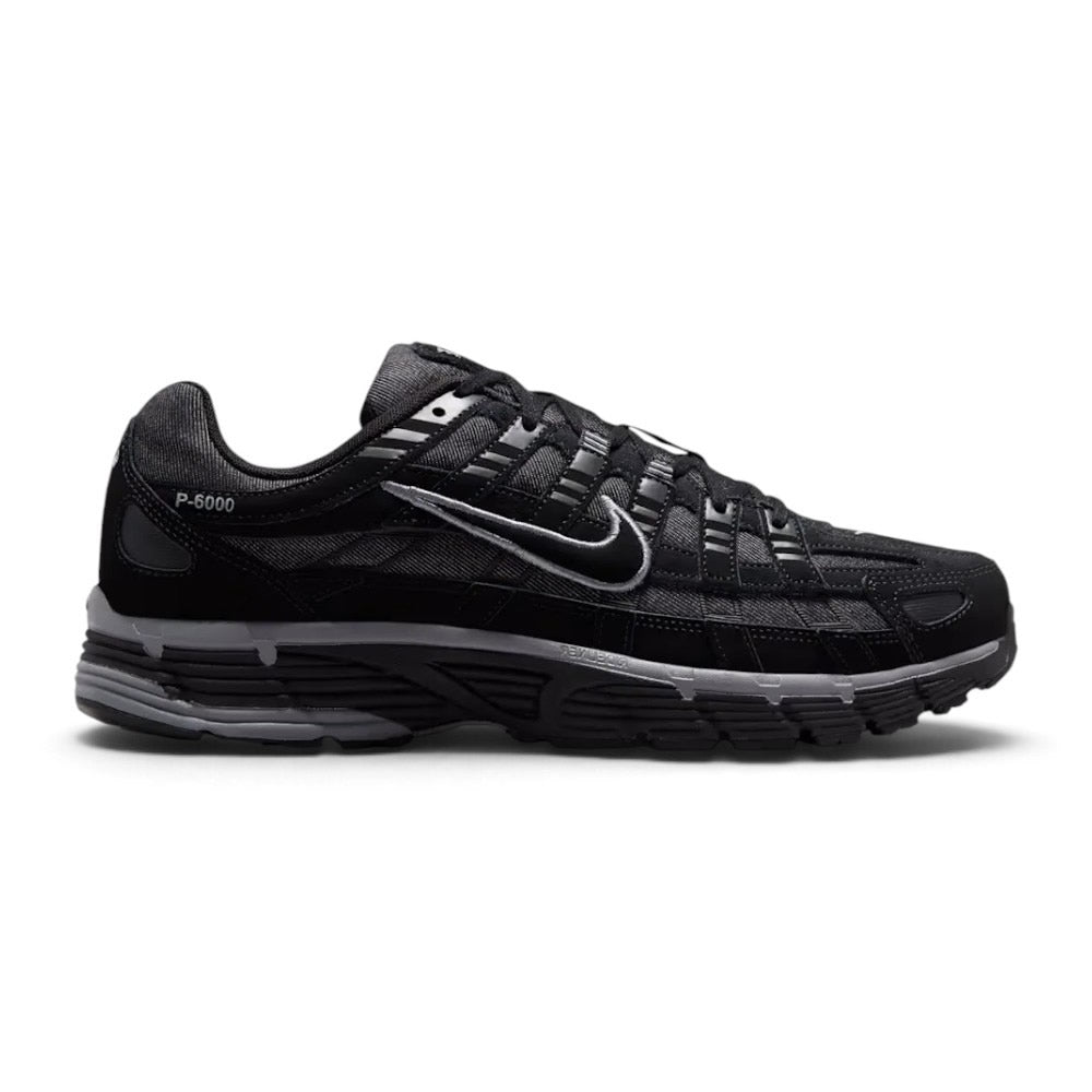 Capturing the 2000s retro running silhouette, detailing the black open-mesh upper, horizontal and vertical anthracite leather overlays, dimensional moulded black Swoosh, sculpted black foam midsole, and dark rubber outsole edge.