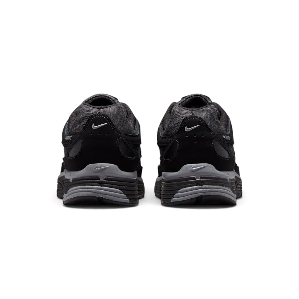 Showing the structured rear heel counter, detailing the layered black leather heel wrap, subtle mini Swoosh embroidery, padded Achilles collar, and sculpted foam heel bevel.