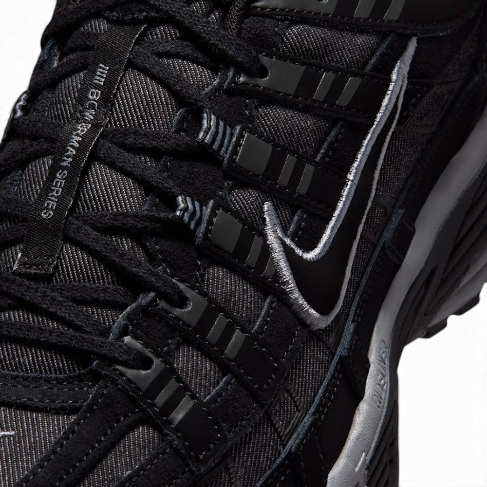 Focusing on the Breathable Open-Hole Mesh Toe Box, Layered Anthracite Cross-Overlays, and Branded Tongue Webbing, demonstrating the upper airflow channels, structural containment boundaries, and refined finish as the stylish final detail.