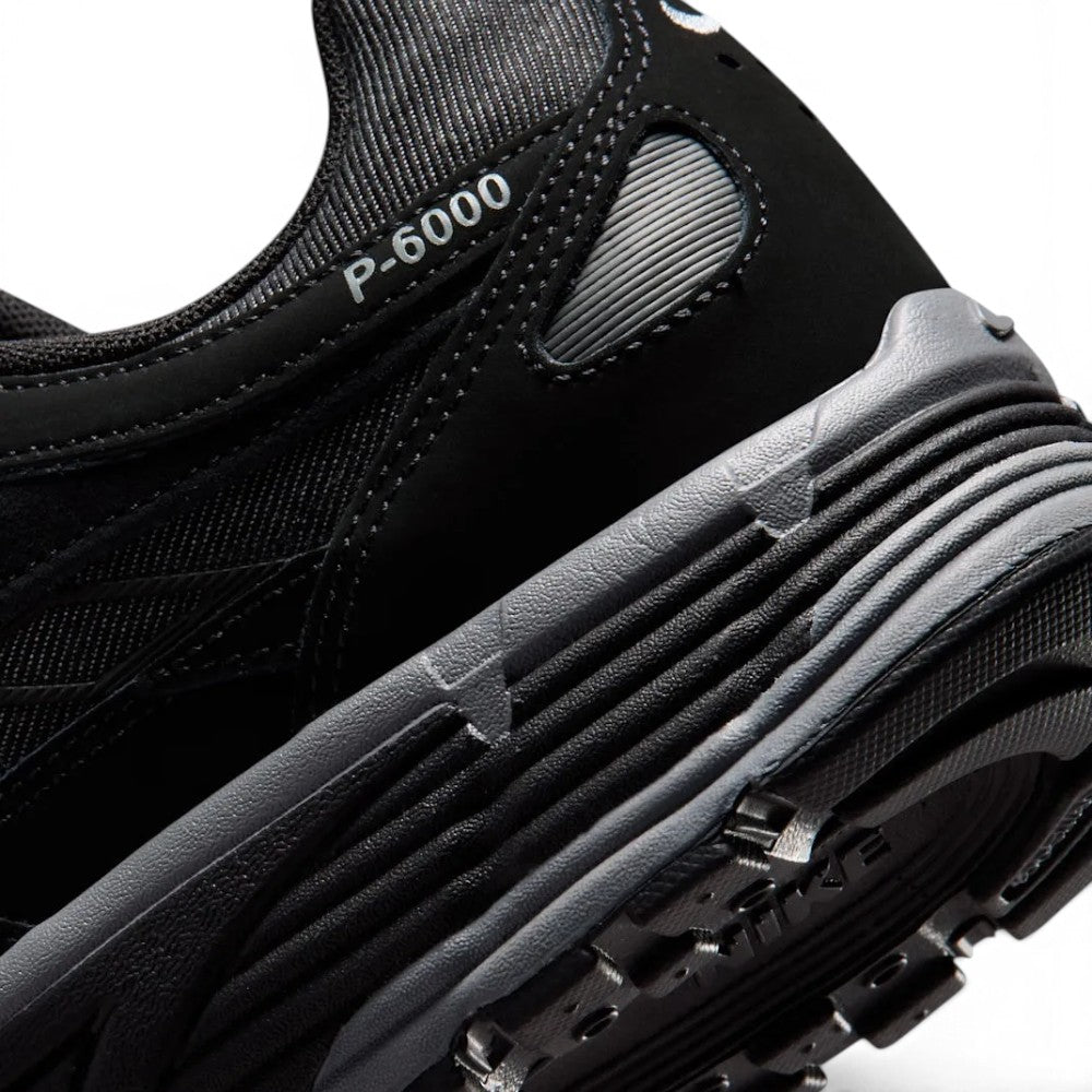 Highlighting the Sculpted Lightweight Foam Midsole Texture, Moulded Synthetic Leather Swoosh Detailing, and Multi-Directional Rubber Tread, demonstrating the impact-absorbing foam depth and retro-tested tooling.