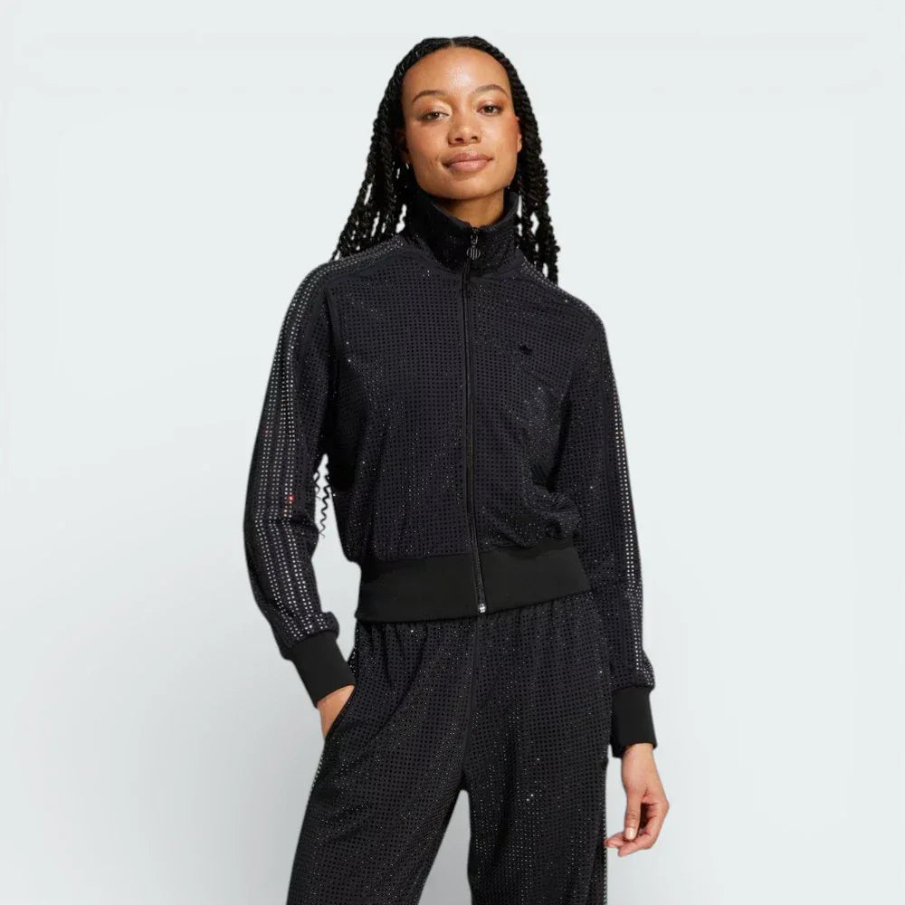Front profile of the Preloved Ruby track jacket, showing the slim-fit silhouette and the iconic contrast 3-Stripes running down the sleeves. Main image