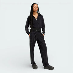 Full profile of the Preloved Ruby track jacket, showing the slim-fit silhouette and the iconic contrast 3-Stripes running down the sleeves wprn by a model