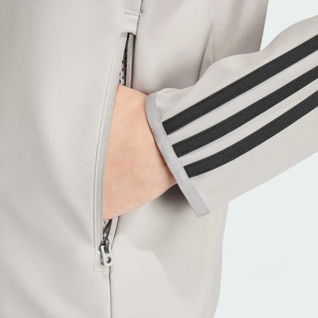 Zoomed-in shot of the Adidas Superstar Men's Bonded Track Top in Medium Grey (IW7318), showing a hand casually placed in one of the zipped pockets.