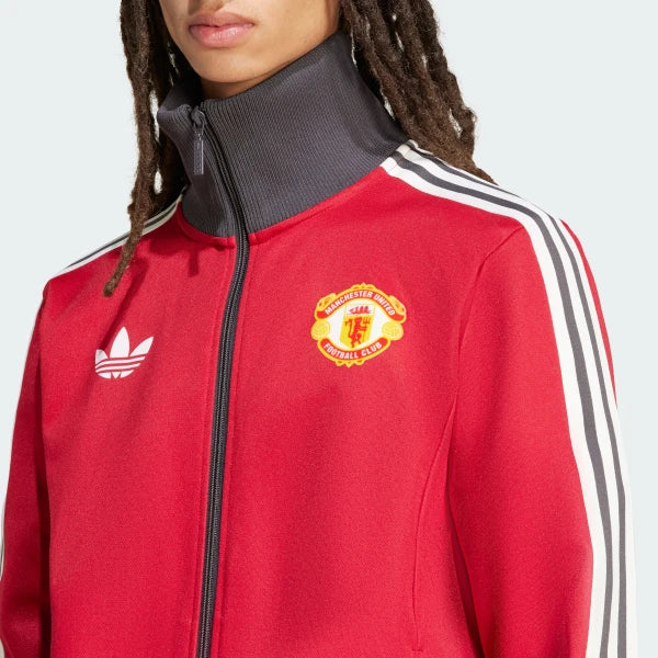A close-up of the intricate embroidery of the Manchester United crest and the heritage Tricolor.