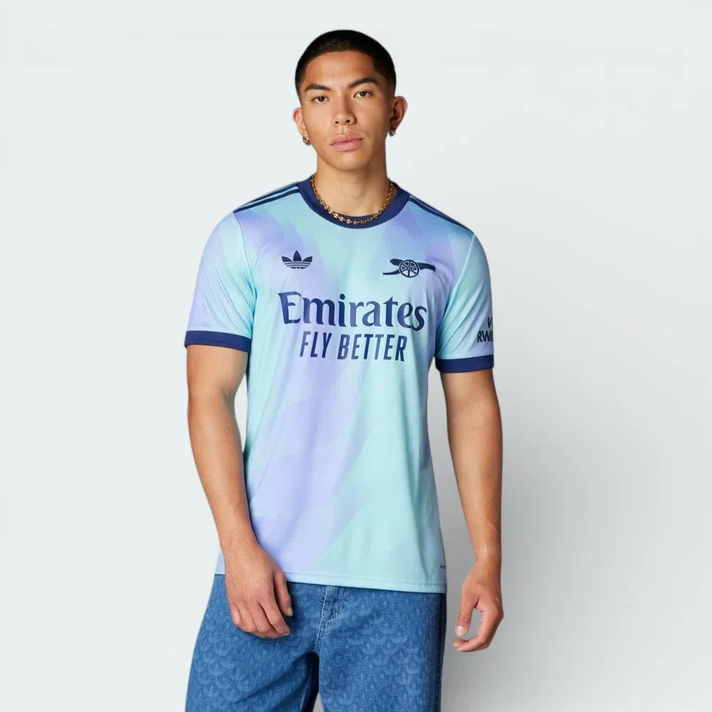 Front profile of the Arsenal 24/25 Third Jersey in Clear Aqua, showing the athletic slim fit and the purple three-stripe detailing on the shoulders. Main image