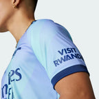 Side profile of the Arsenal 24/25 Third Jersey in Clear Aqua, showing the athletic slim fit and the purple three-stripe detailing on the shoulders.