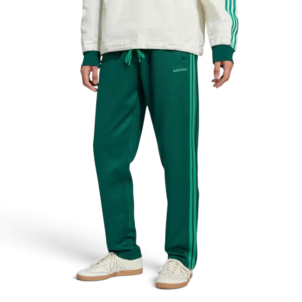 Side profile of the Collegiate Green Heritage pants, highlighting the textured piqué fabric and the crisp white 3-Stripes. Main image