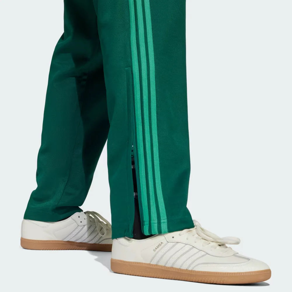 Zoom looking at the 3-Stripes and seams, showcasing the high-contrast white-on-green finish and premium construction.