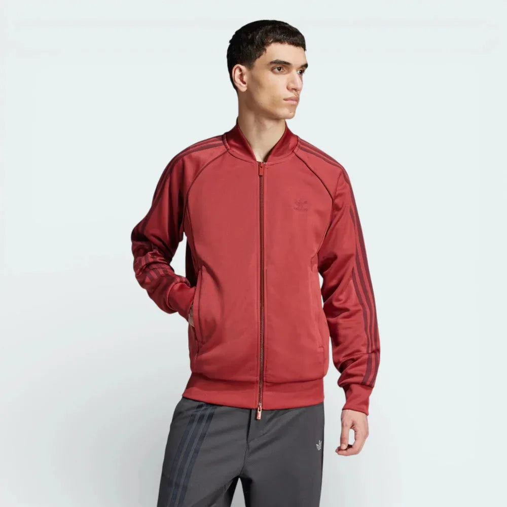 Front profile of the Preloved Ruby track jacket, showing the slim-fit silhouette and the iconic contrast 3-Stripes running down the sleeves.