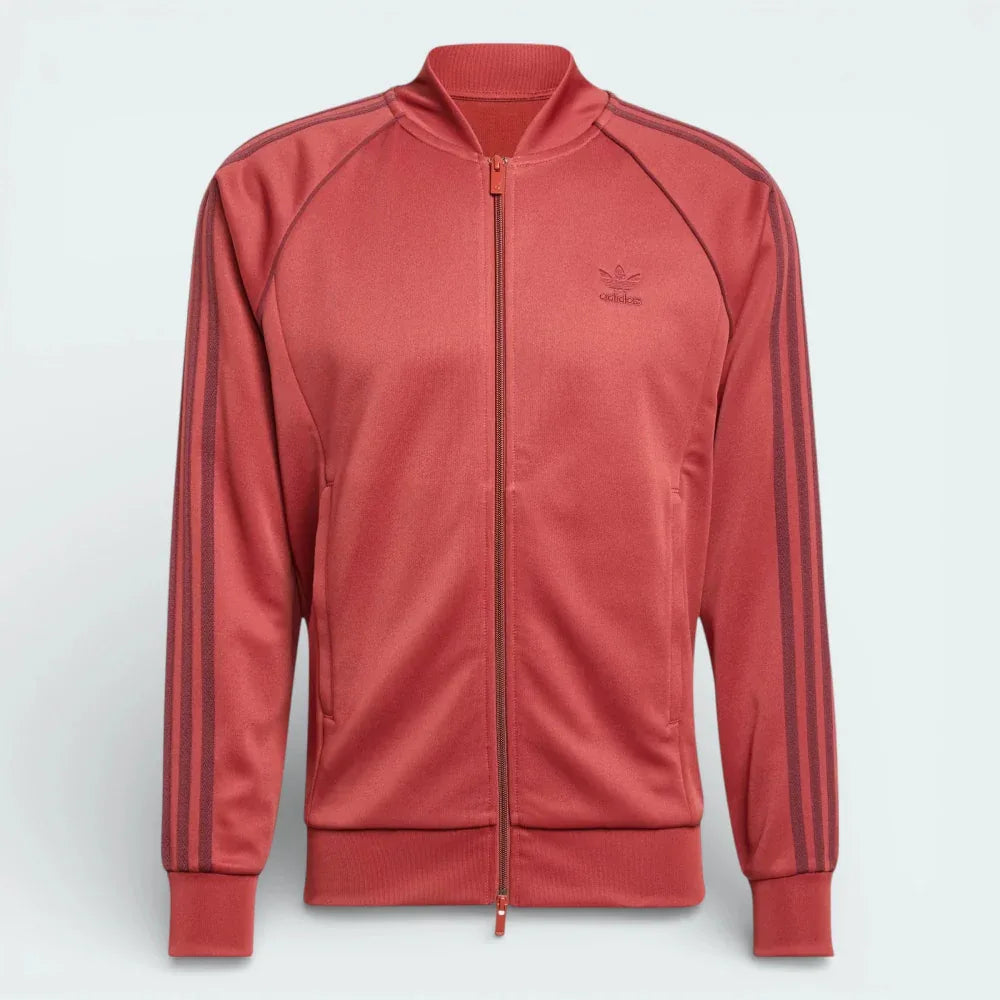 Red tracksuit jacket with Adidas logo on a light gray background