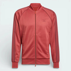 Red tracksuit jacket with Adidas logo on a light gray background