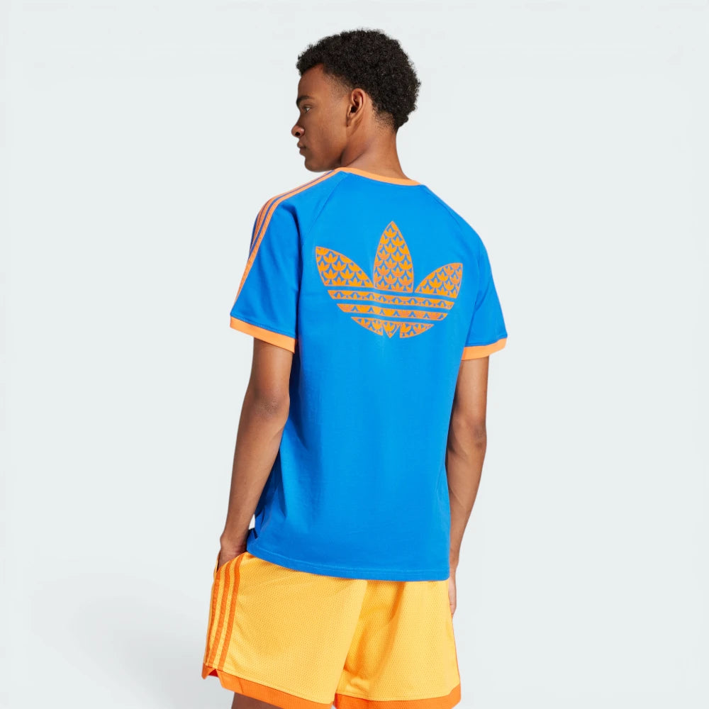 Side profile of the blue Adidas t-shirt, highlighting the slim fit and the textured ribbed cuffs on the sleeves.