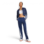 Person wearing a blue tracksuit with white stripes on a light gray background