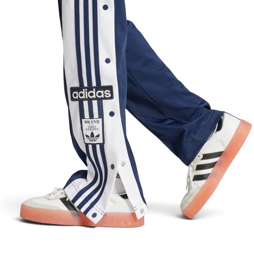 A close-up showing the bottom snap buttons opened to reveal a glimpse of the footwear underneath.
