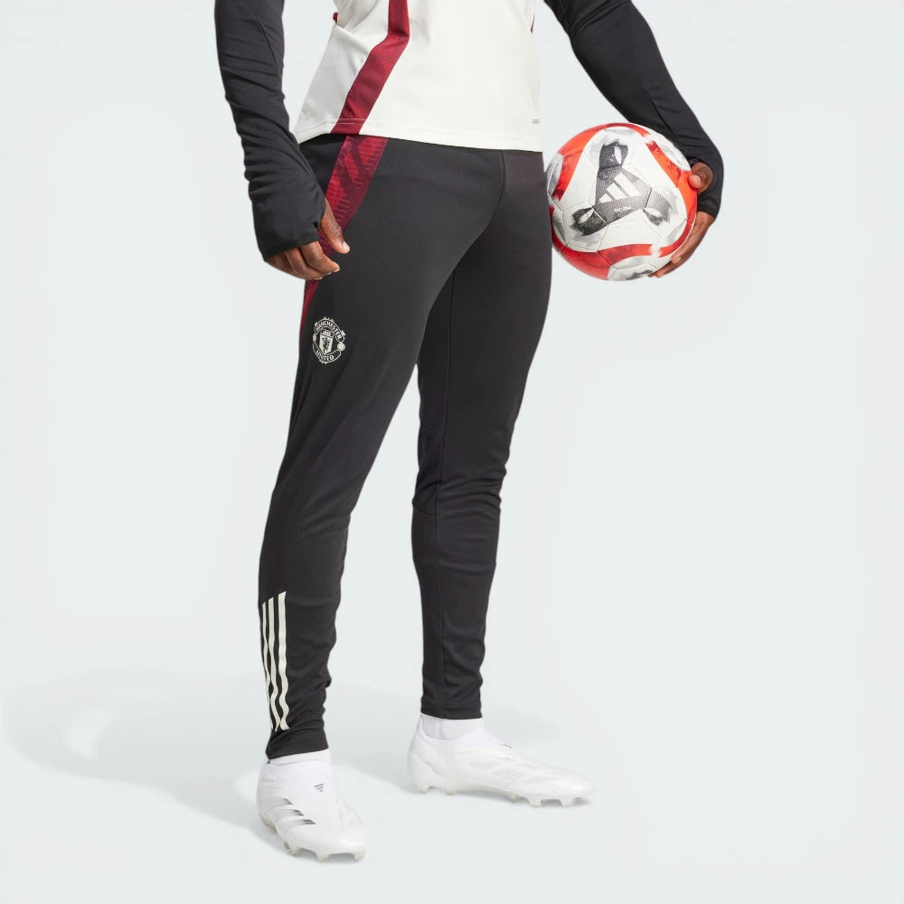 The Black Tiro 24 pants, highlighting the slim-cut legs and the signature white Adidas 3-Stripes.