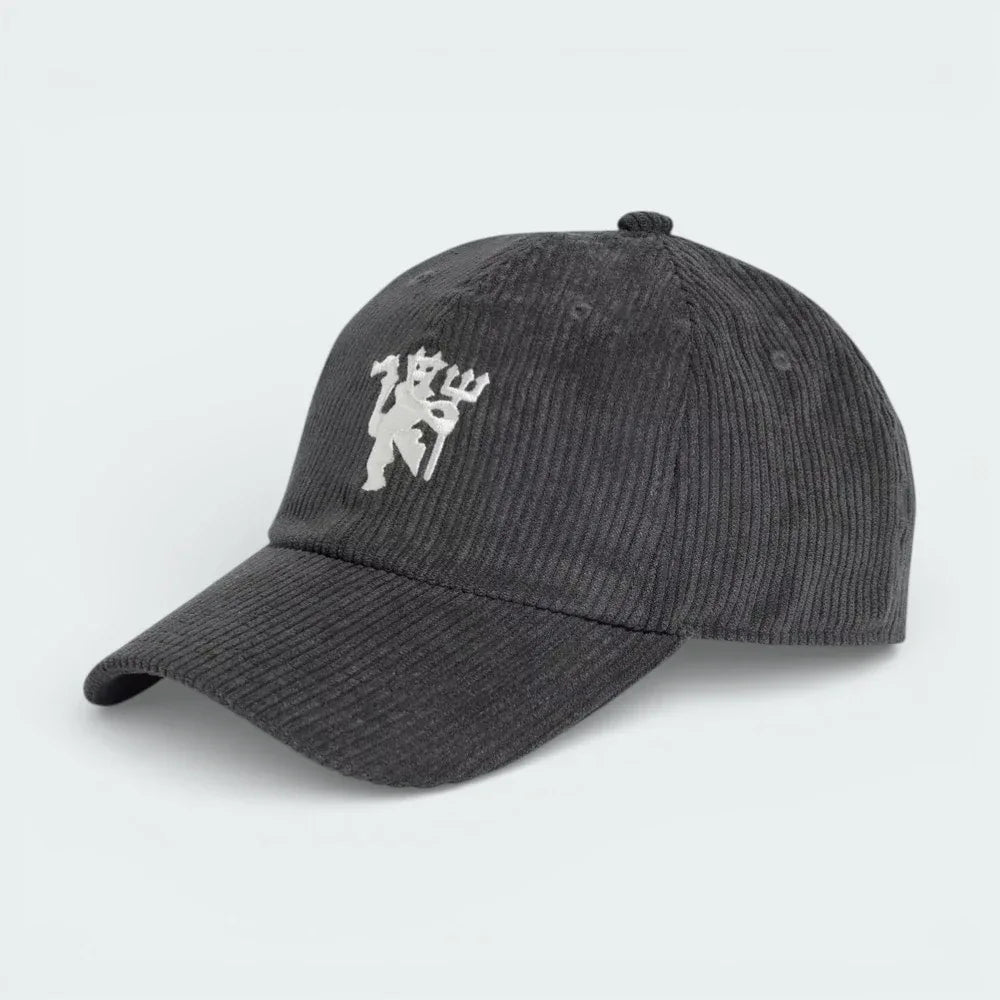Side profile of the black corduroy Manchester United cap, showing the textured ribbed fabric and the classic curved brim. Main image