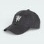 Side profile of the black corduroy Manchester United cap, showing the textured ribbed fabric and the classic curved brim.