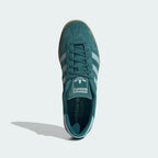 Looking down at the green suede lacing system and the tonal branding on the tongue.