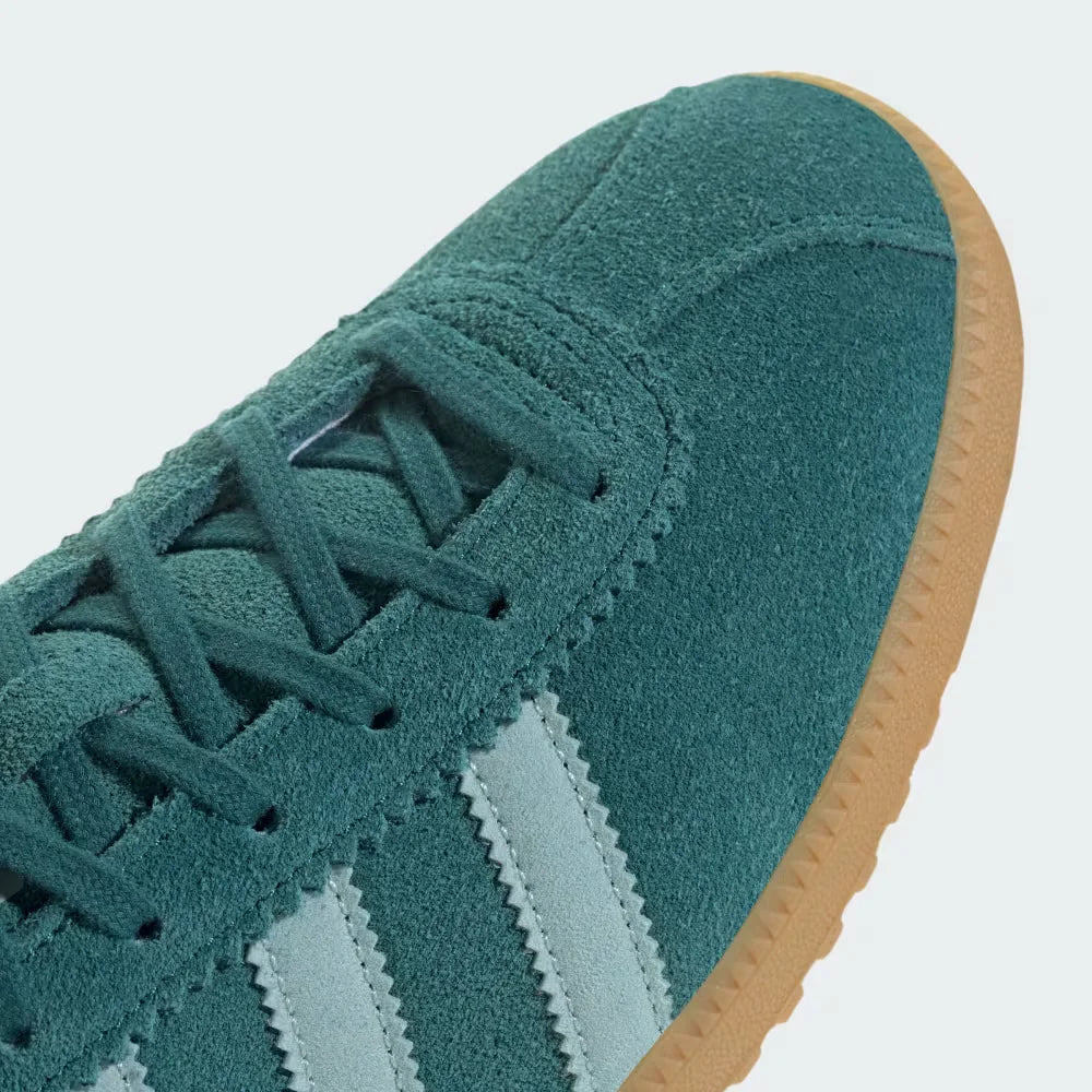A close-up of the fine suede grain and the precision stitching around the toe box.