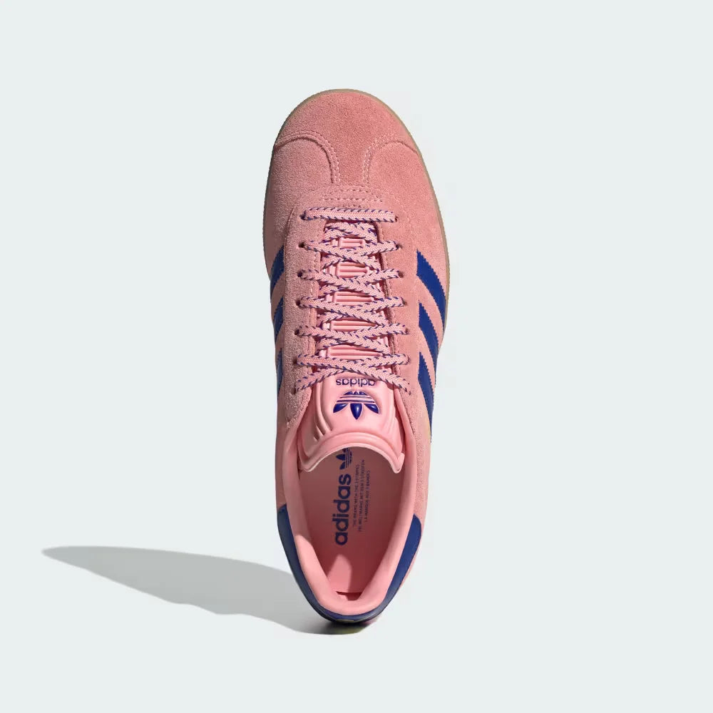 Looking down at the pink suede lacing system and the Pure Sulphur yellow branding on the tongue.