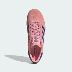 Looking down at the pink suede lacing system and the Pure Sulphur yellow branding on the tongue.